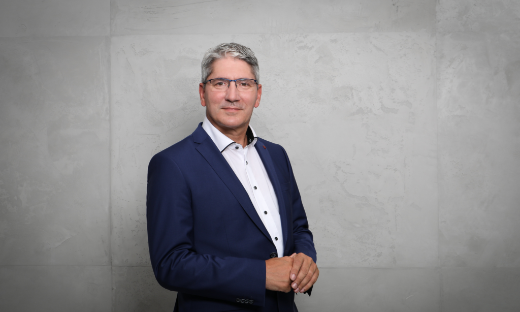 Untitled-design-2024-09-28T165816.940-1024x614 a man wearing a blue suit