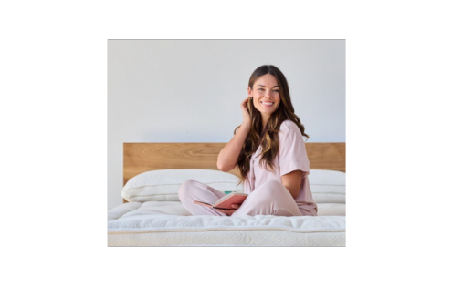A woman with polycystic ovary syndrome sitting on her bed.