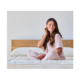 A woman with polycystic ovary syndrome sitting on her bed.