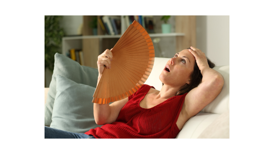 Hormonal imbalanced women having a hot flash.