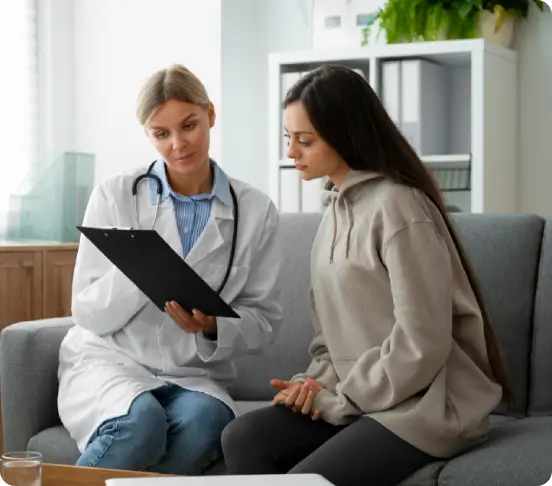 Philly Wellness Center functional medicine doctor in Philadelphia talks with a patient during an initial evaluation about symptoms, goals, and health/medical history.